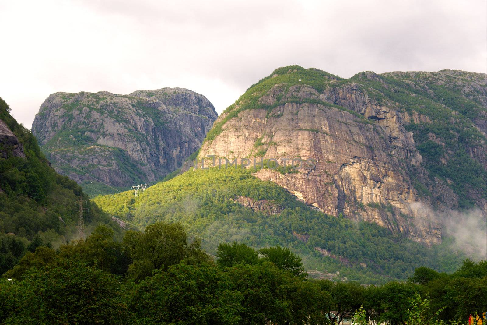 Mountains in the rays of the setting sun by Nanisimova