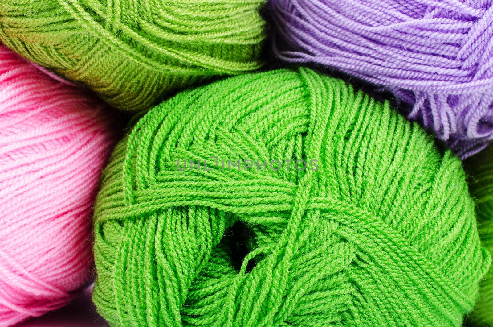 Multi-colored balls of yarn close up