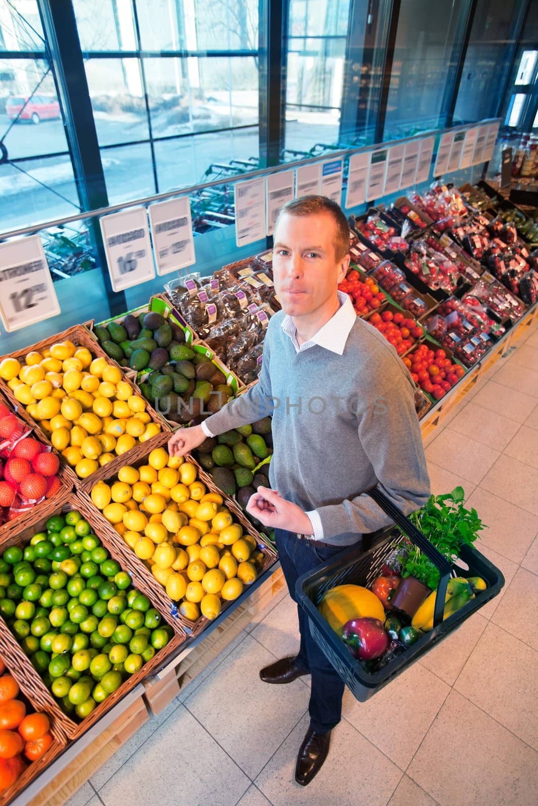 Portrait of a man buying fruits by leaf