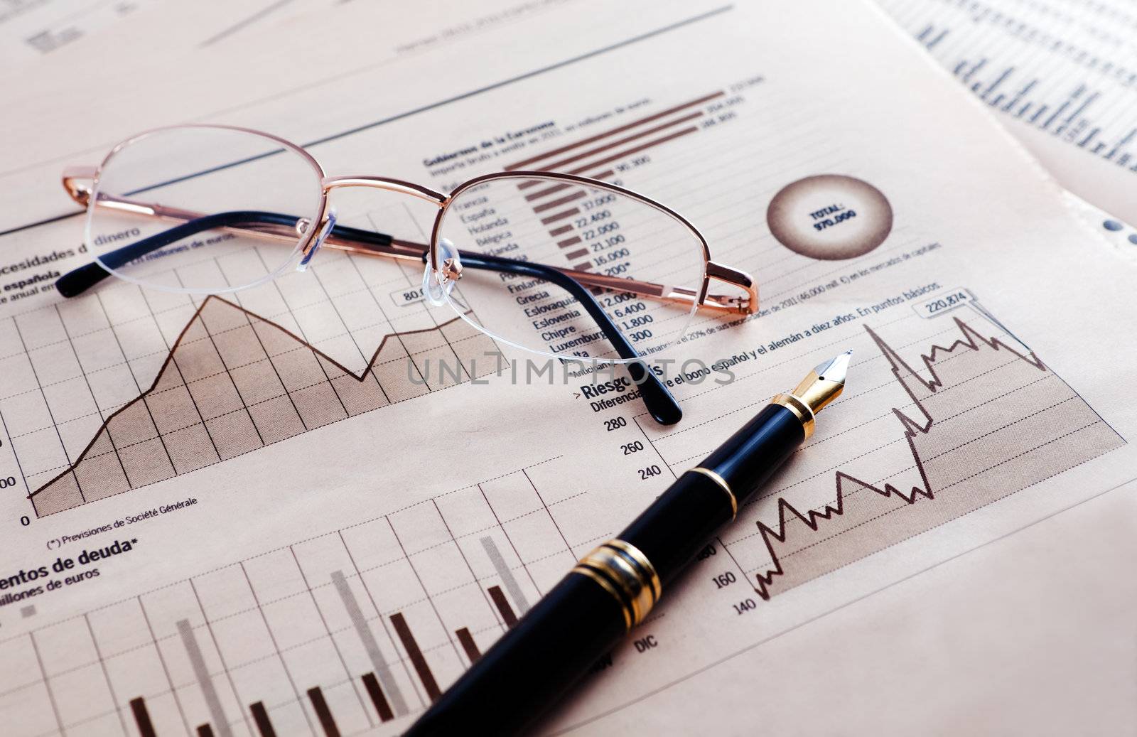 Business background with graphics,glasses and pen