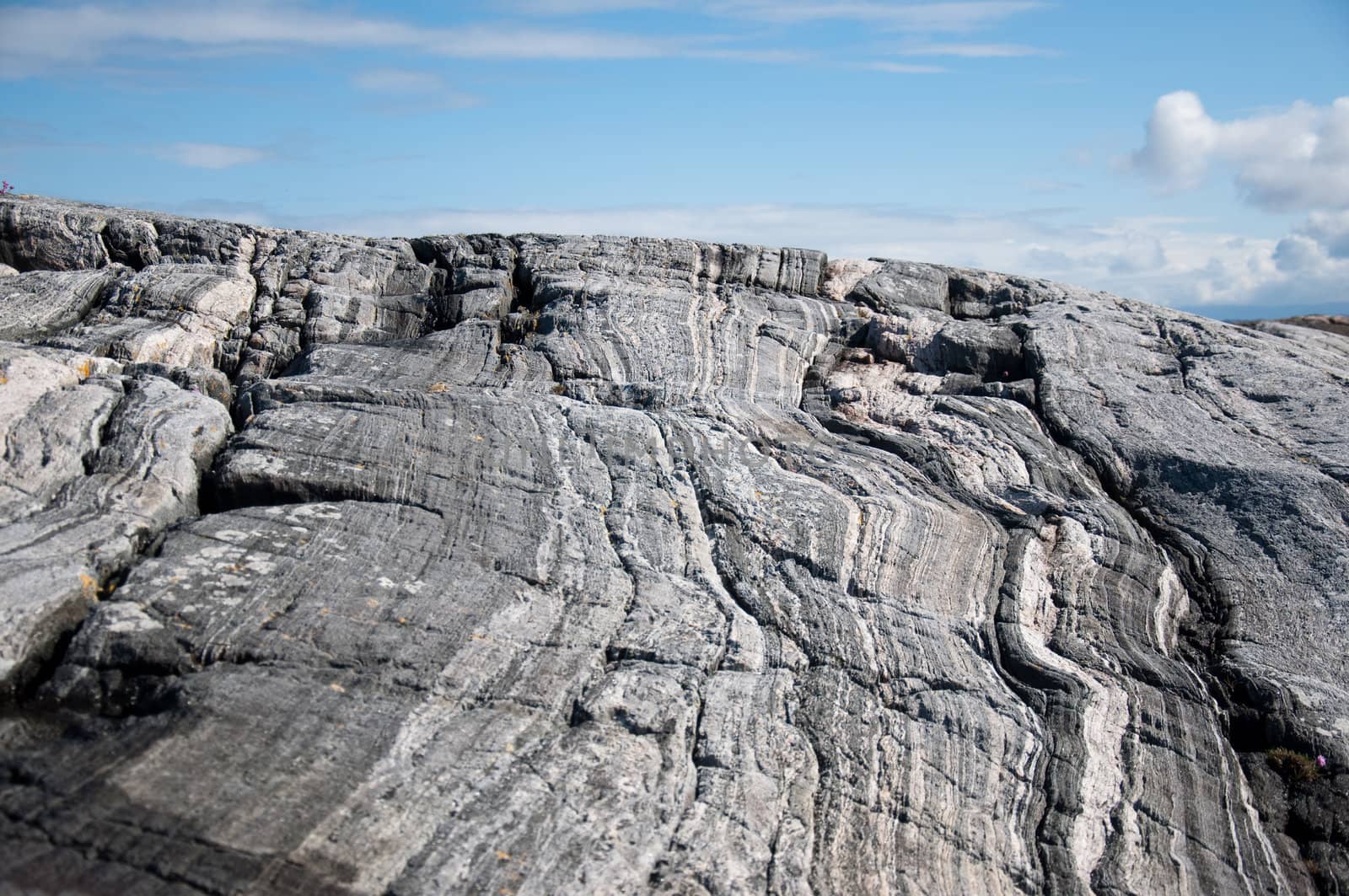 Large gray rock on the sky background close up