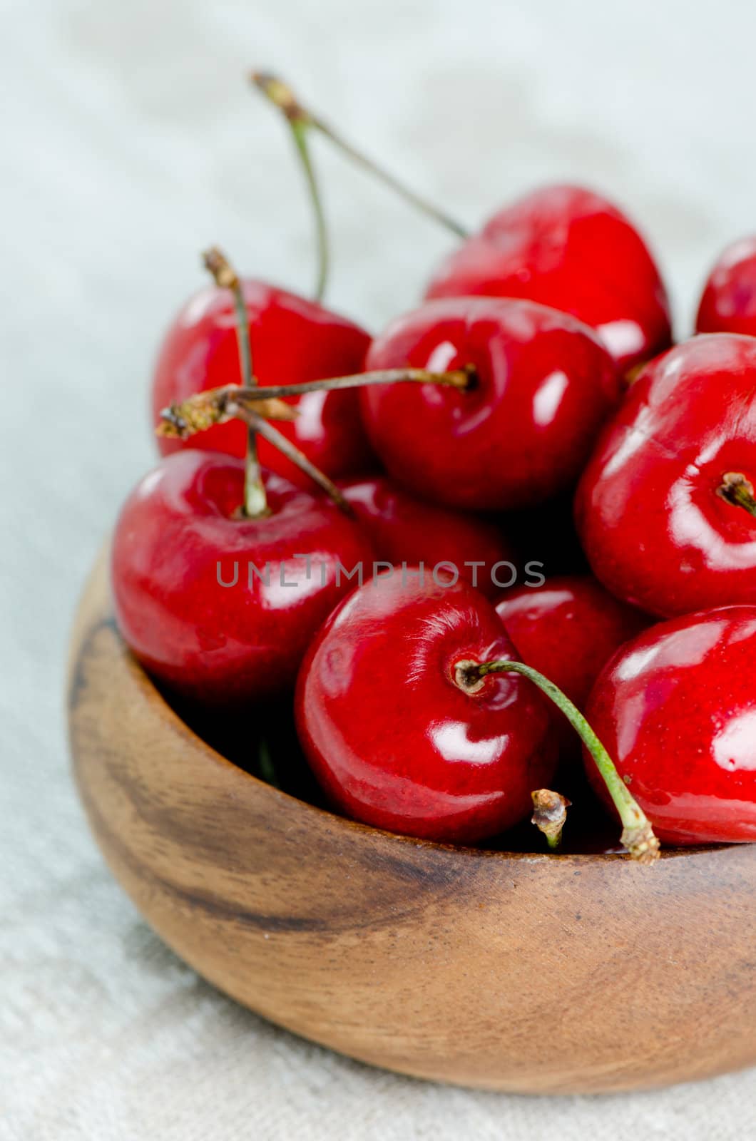 Bunch of cherries in a wooden bowl