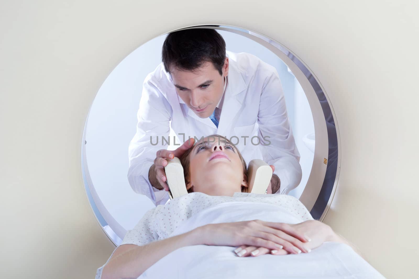 Technologist preparing the patient for a CT scan in hospital