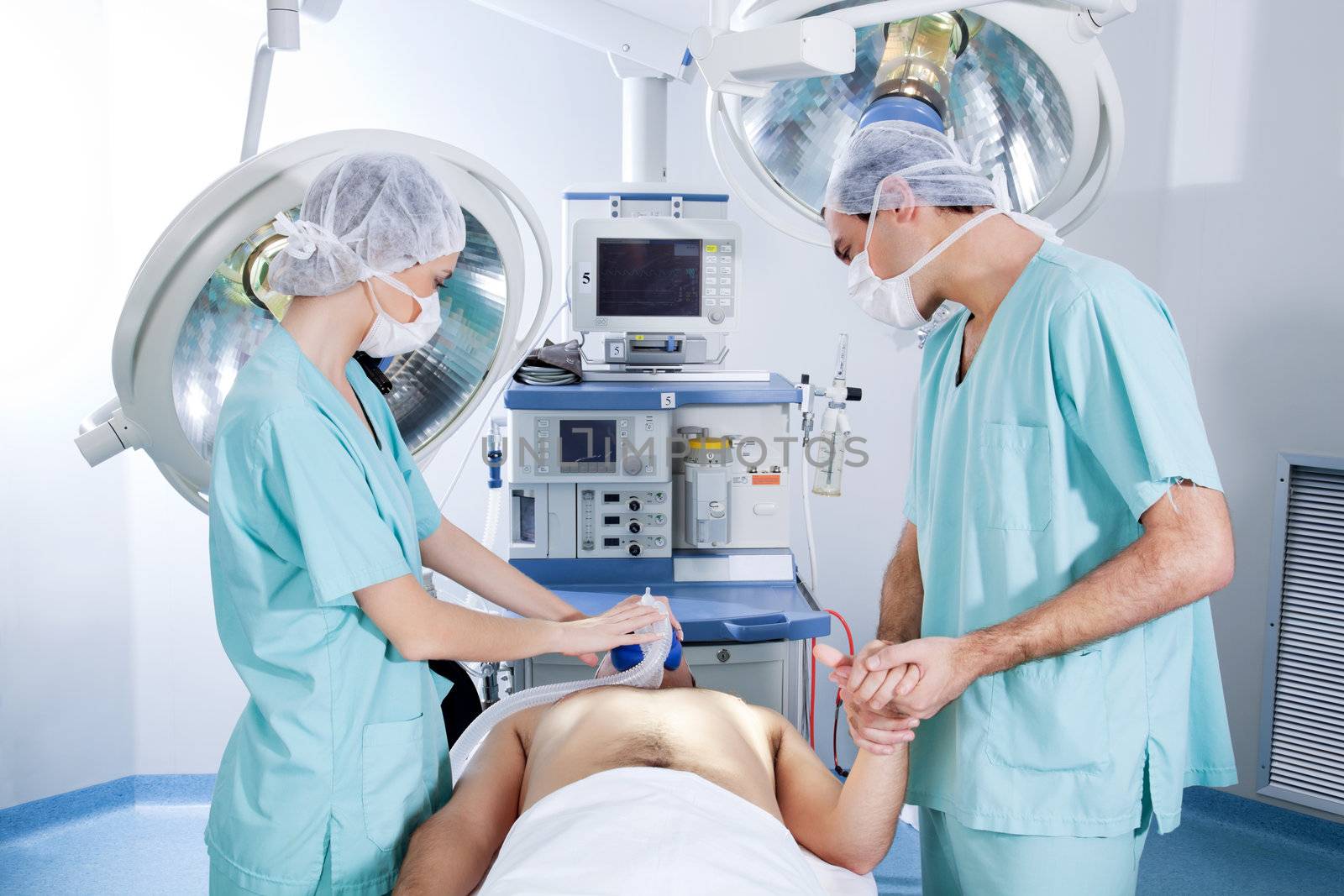Surgeons operating on patient in an operating theatre