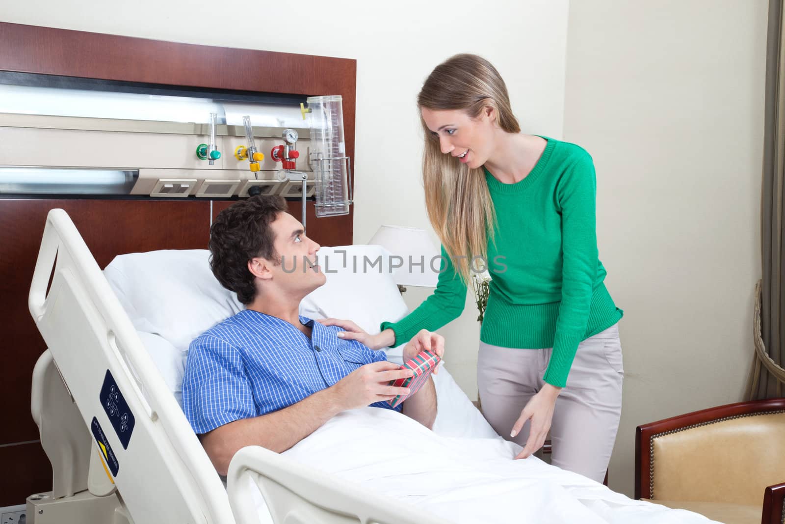 Young woman paying a visit to the patient in hospital