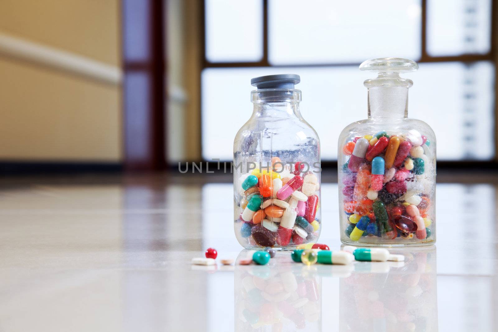 Medical capsules and tablets in a bottle by leaf