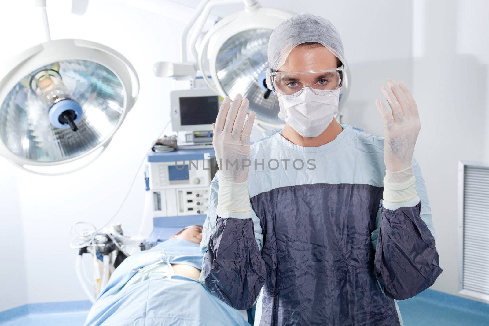 Portrait of male surgeon in operation theatre by leaf
