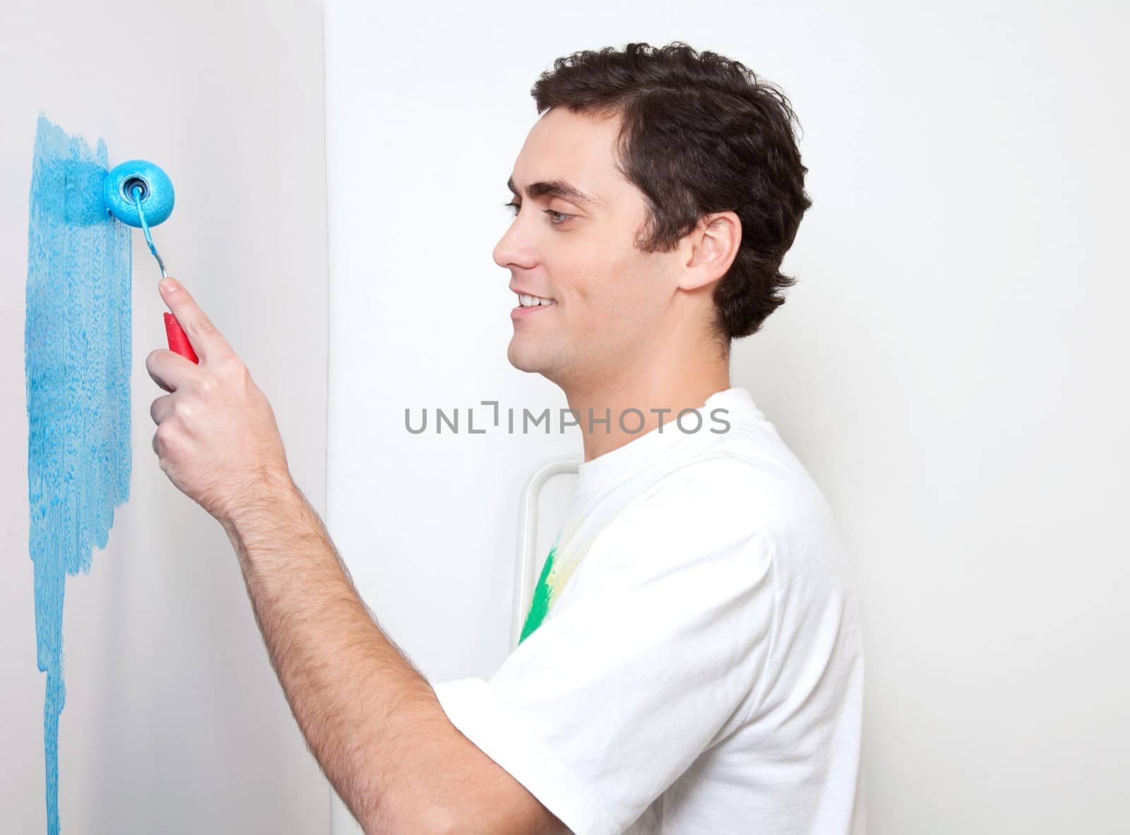 Happy young man applying color by leaf