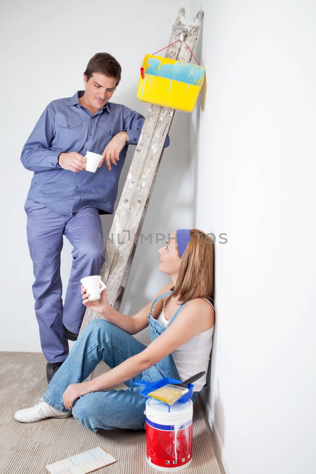 Man and woman having a cup of coffee at their new apartment