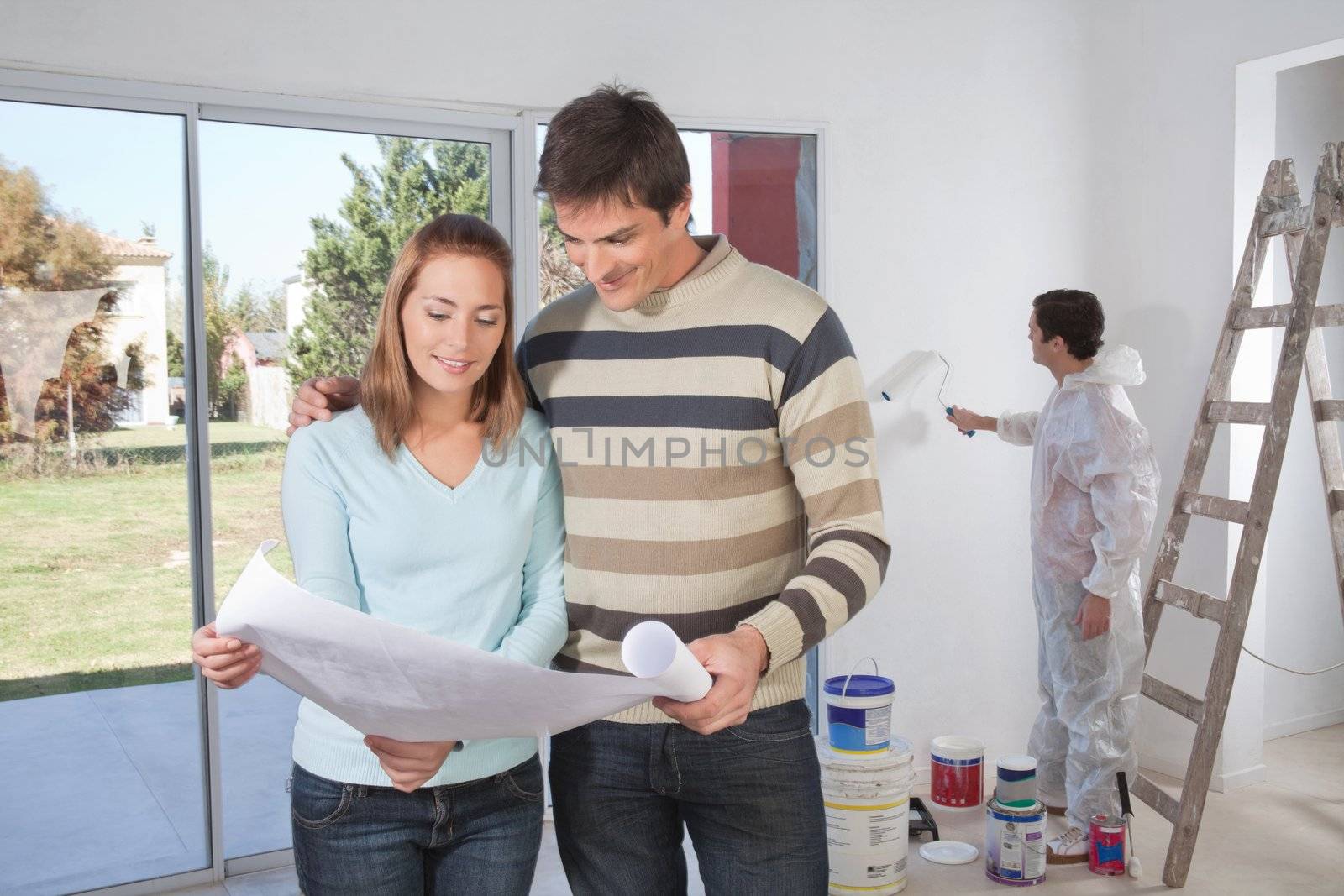 Couple going through house plan by leaf