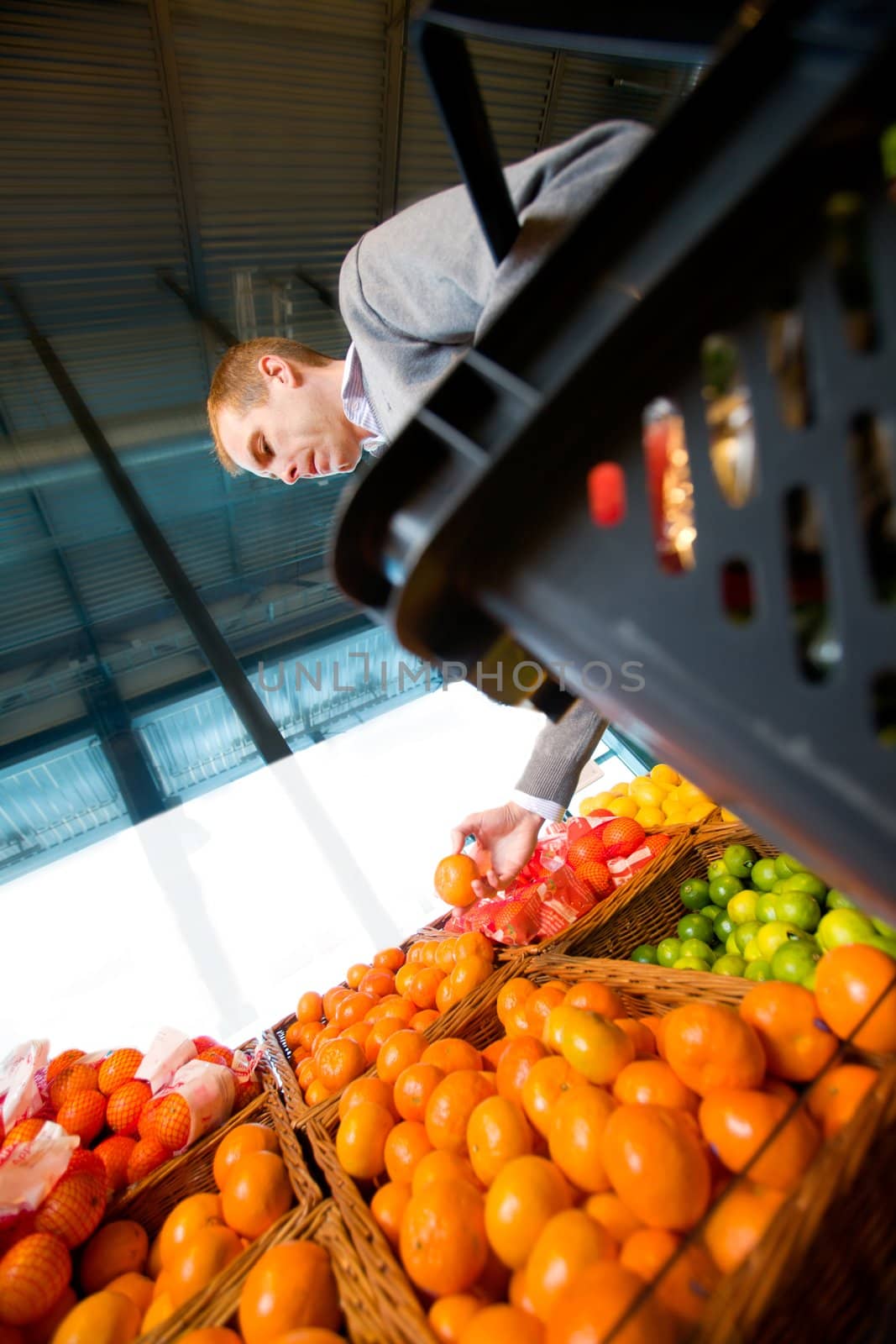 A man buying fresh fruit at a grocery store