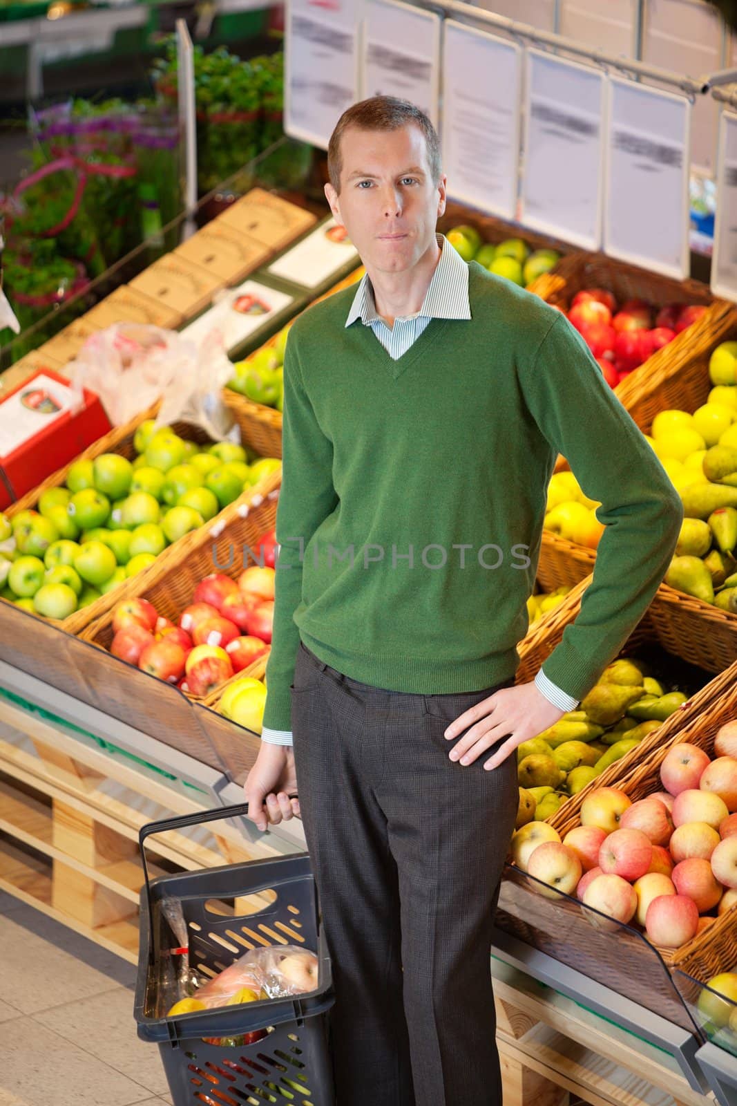 Portrait of serious man in shopping centre by leaf