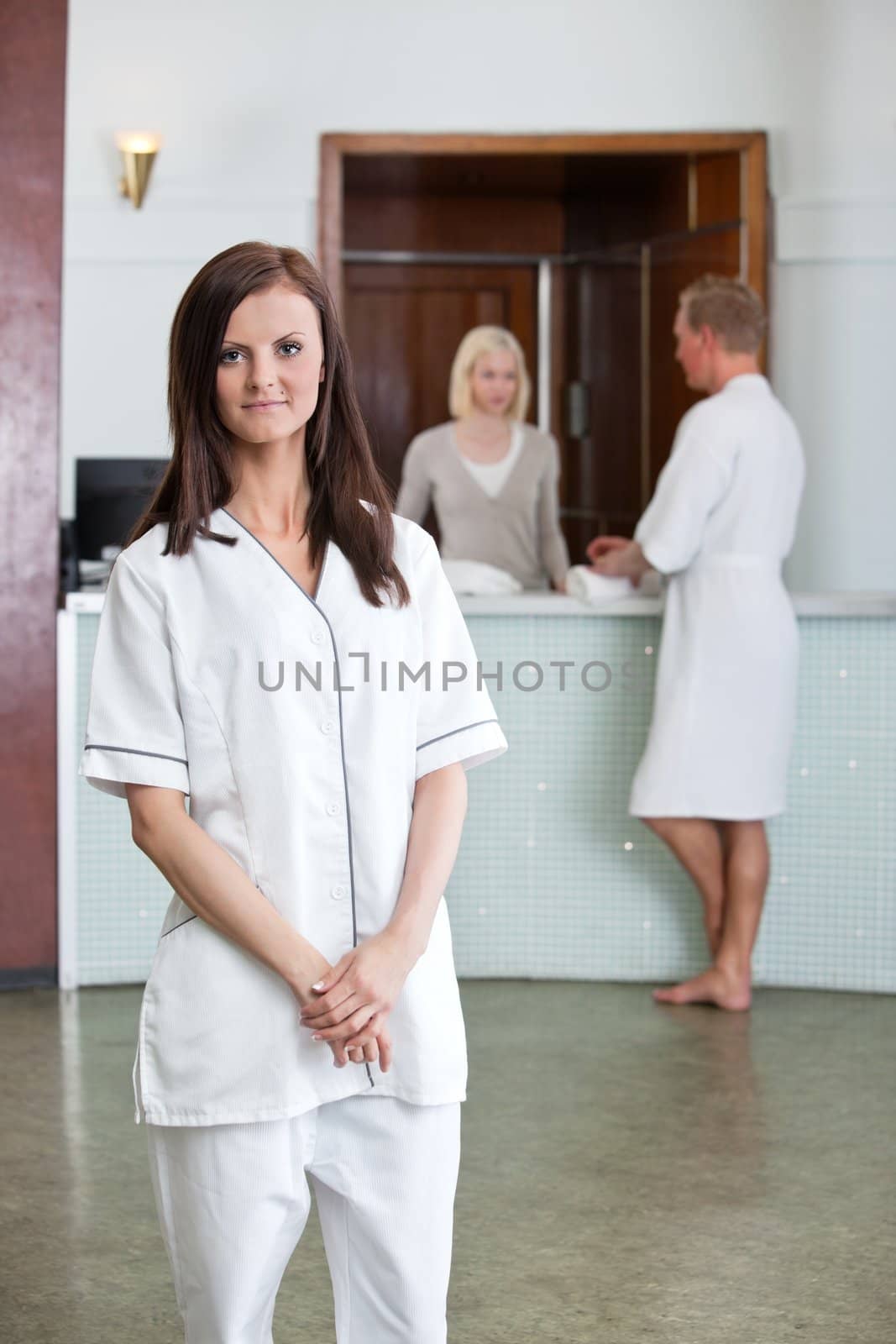 Young Caucasian woman with people in background at spa centre
