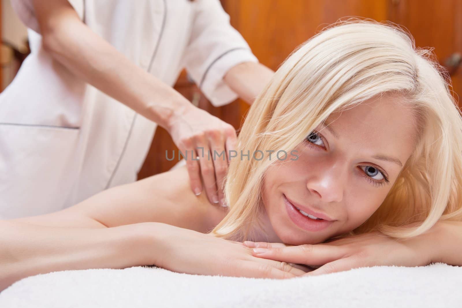 Portrait of a charming woman having a massage in a spa