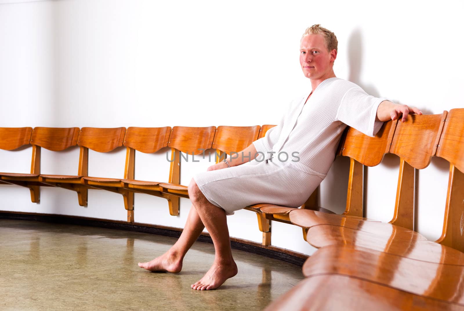 A man in a reception area of an old funkis styled spa