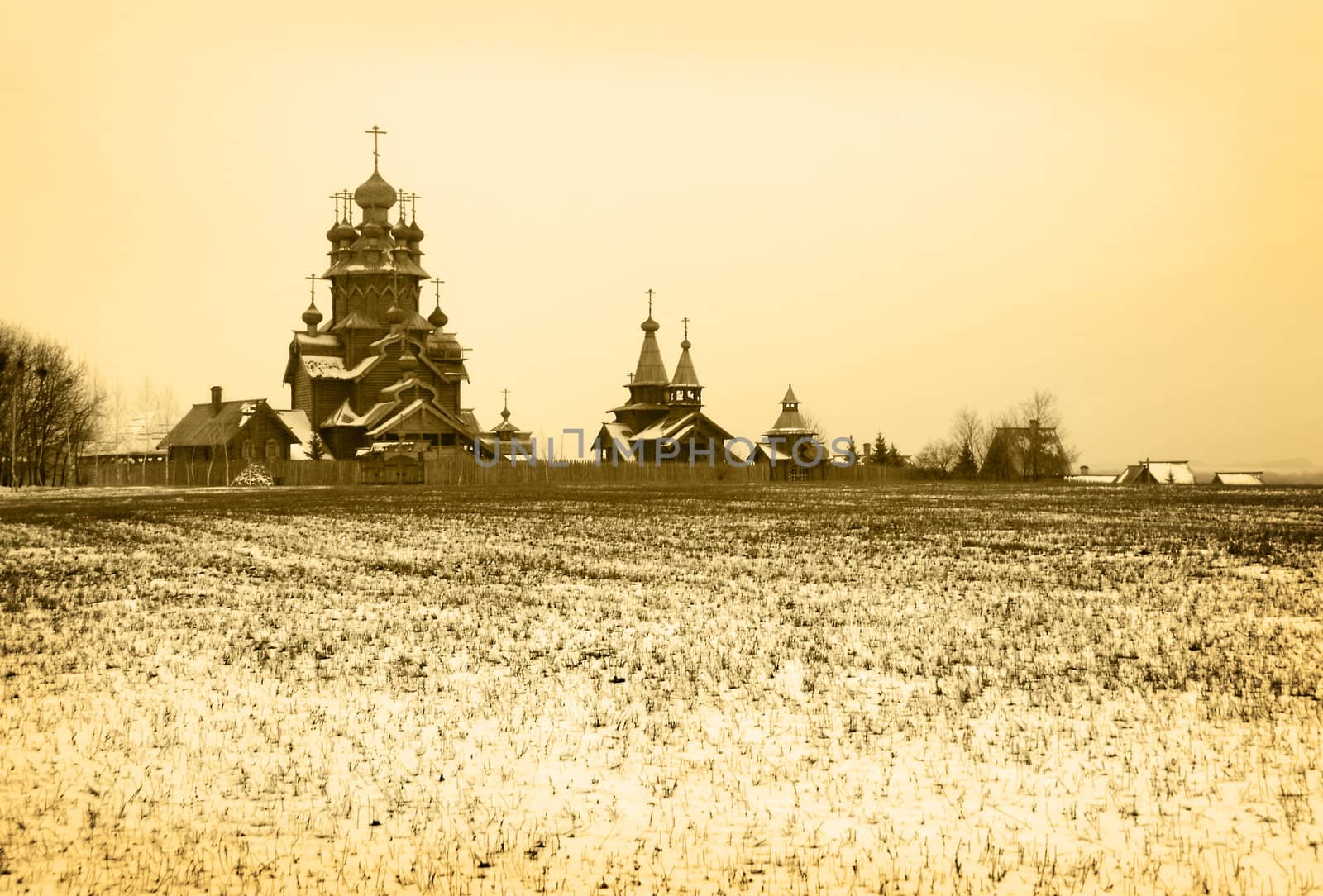 Old orthodox wooden church in winter snow-covered field. Ukraine, Donetsk region.