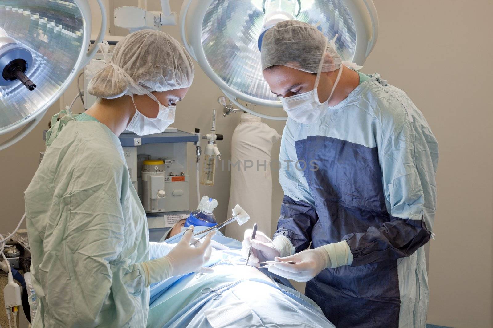 Medical doctor performing an operation on patient in operating room