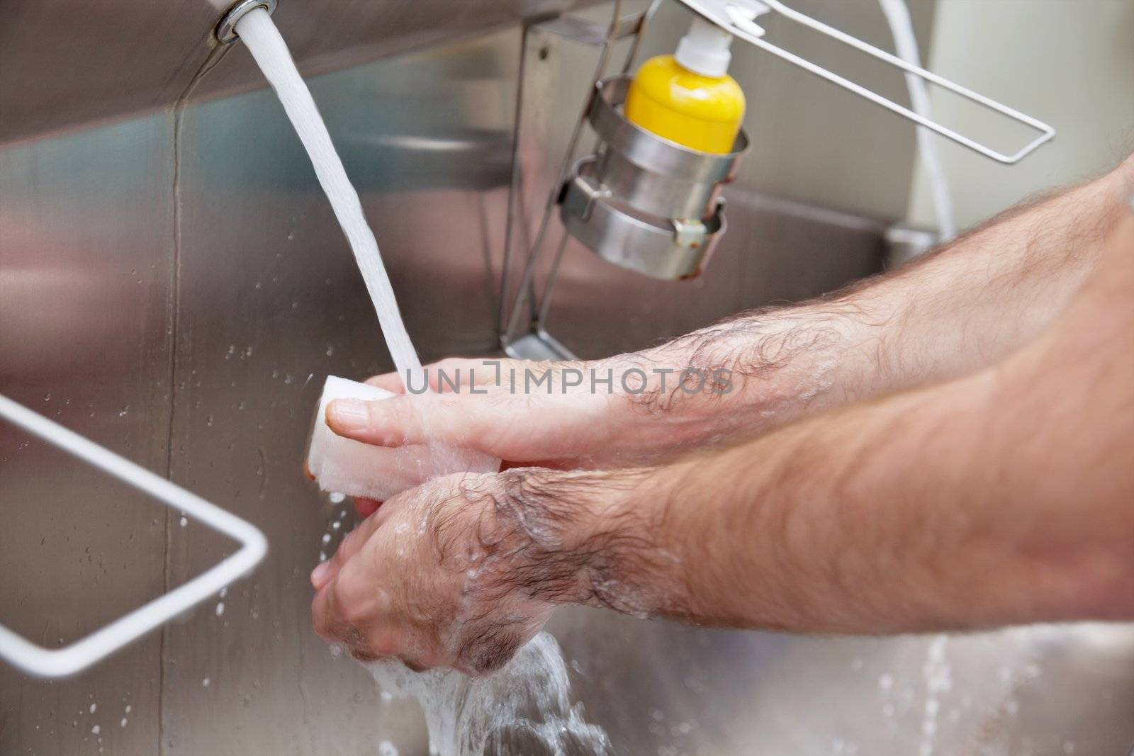 Doctor washing hands by leaf