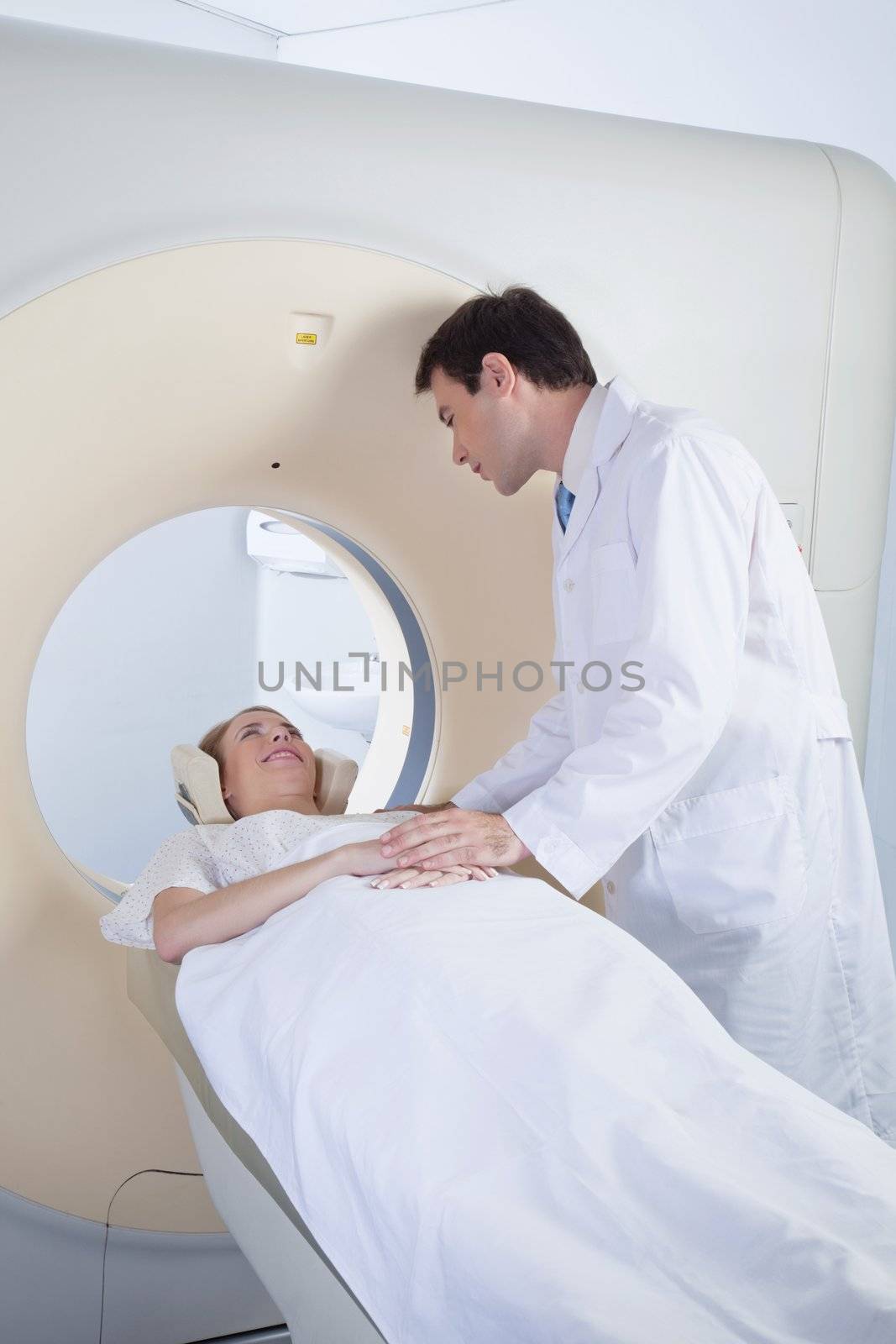 Woman receiving CT scan test by leaf