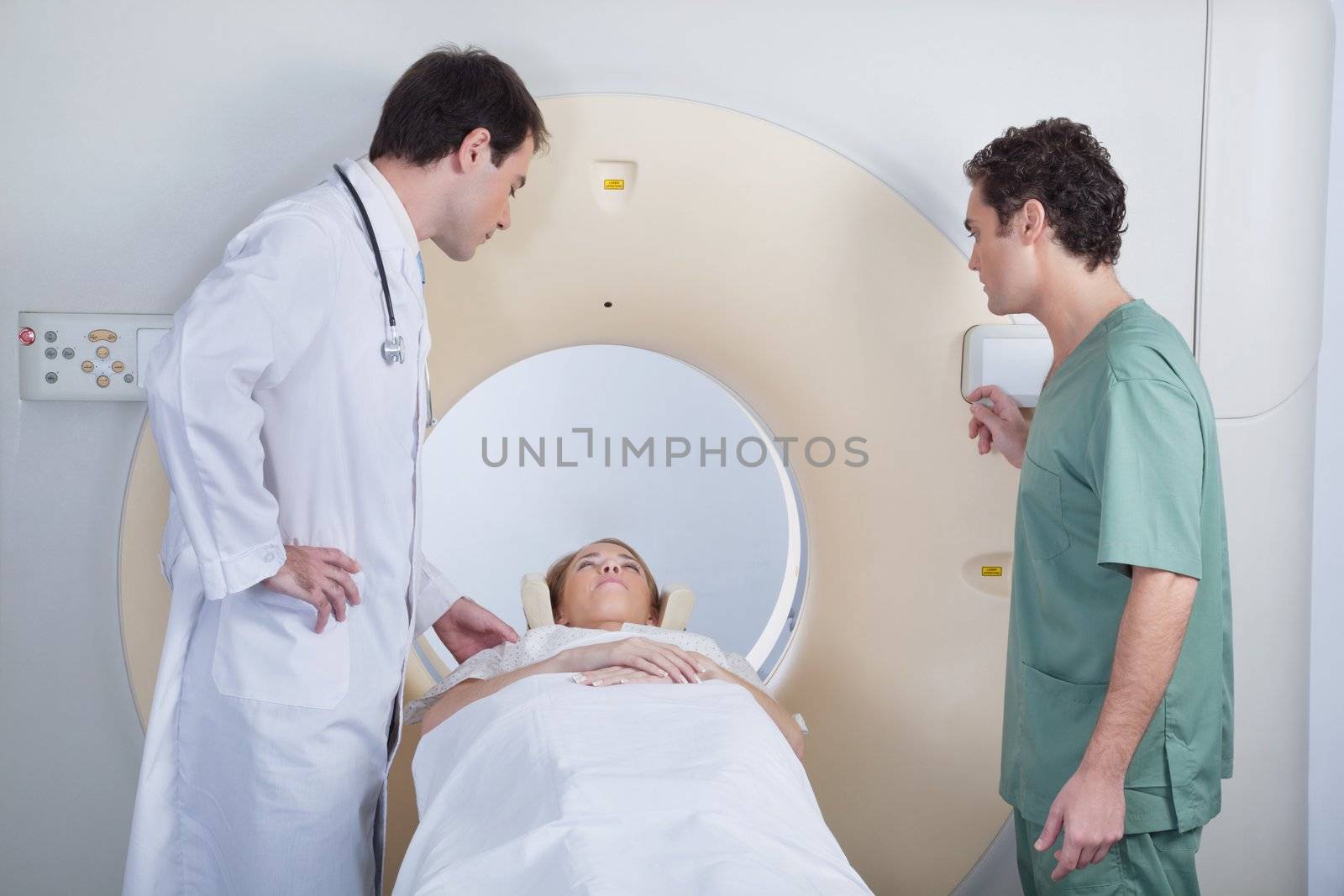 Doctor with technician examining patient by leaf
