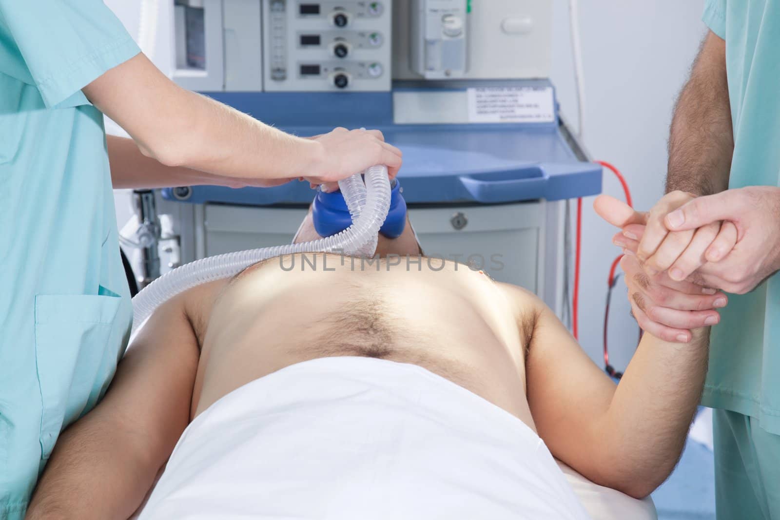 An anesthetist preparing a patient for surgery