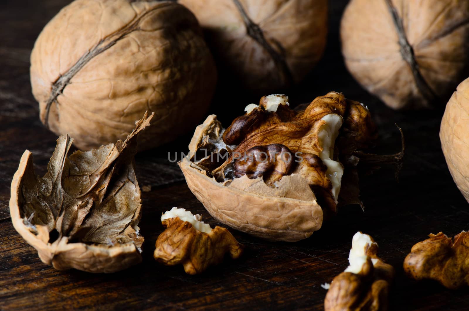 Cracked walnuts on wooden table