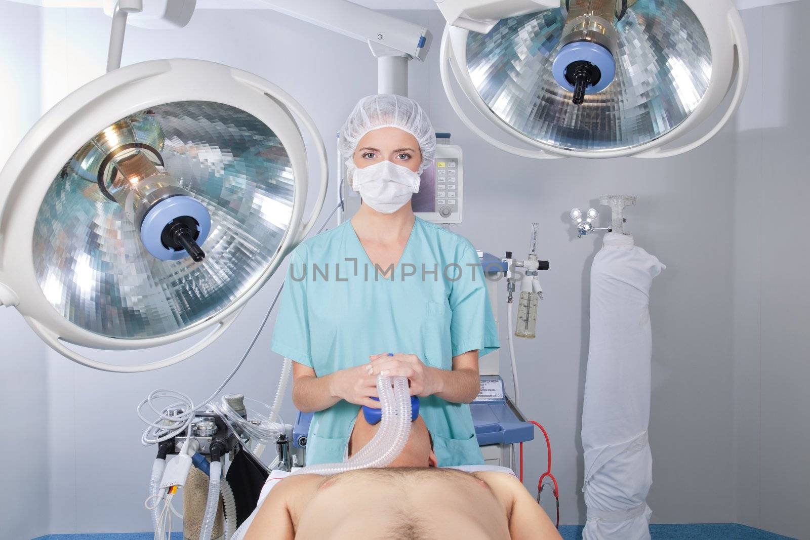 An anesthetist with patient in an operating room