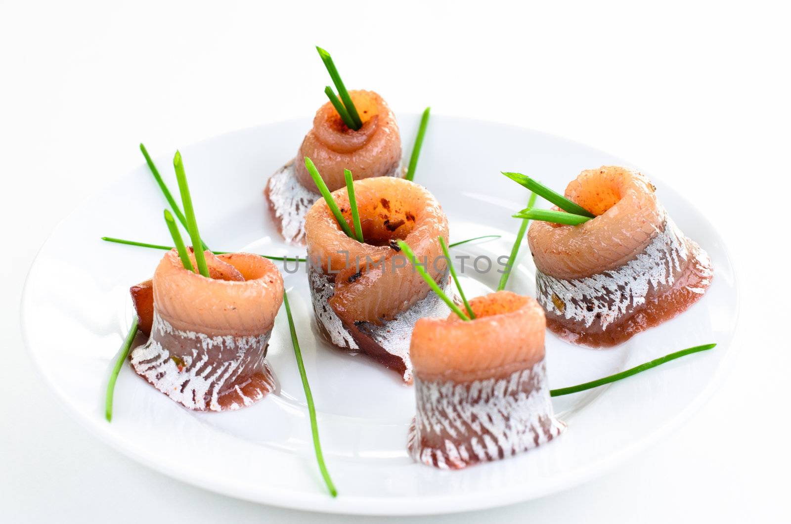 Marinated herring close up with spring onion