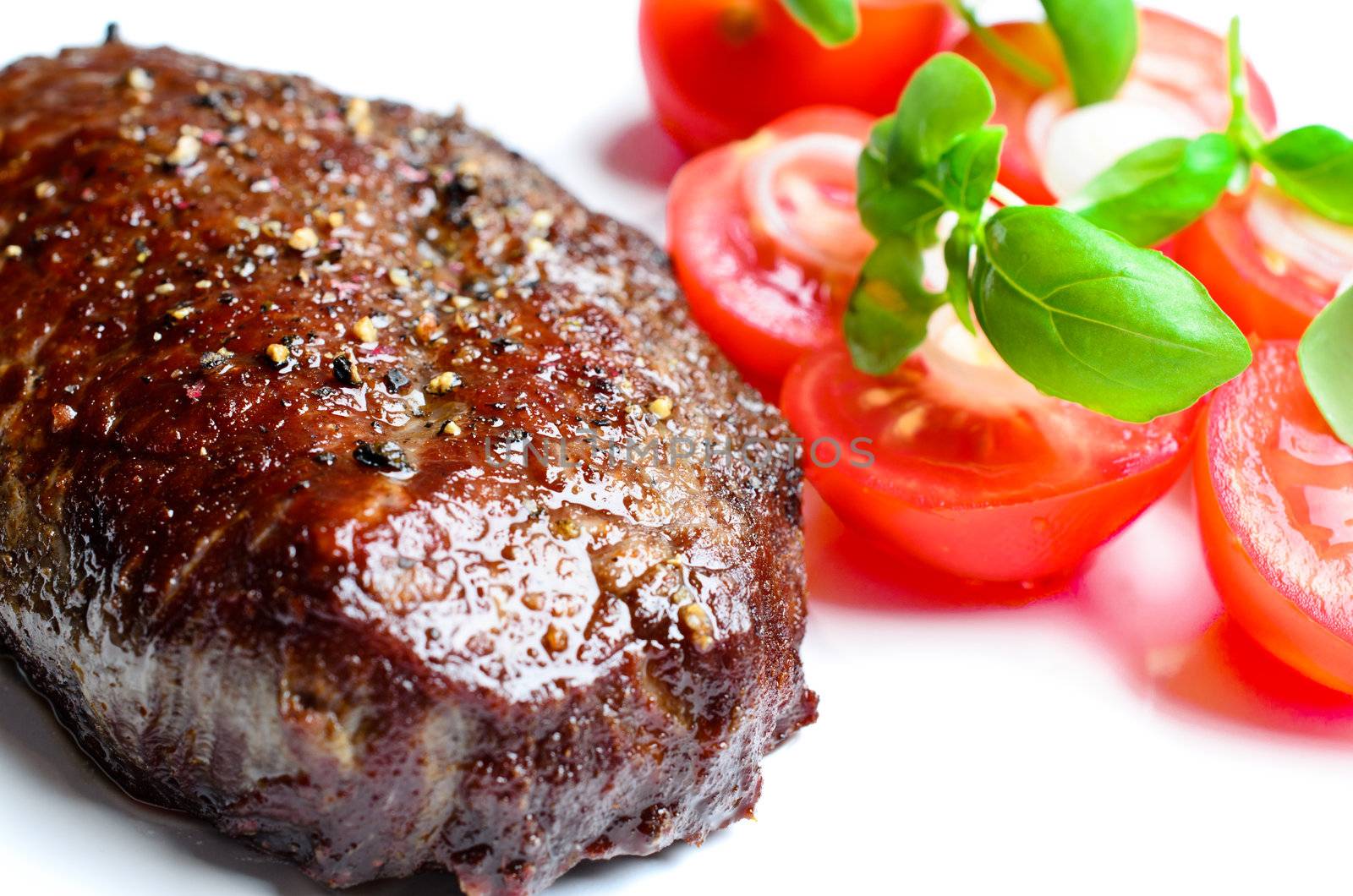 Steak with tomatoes close up