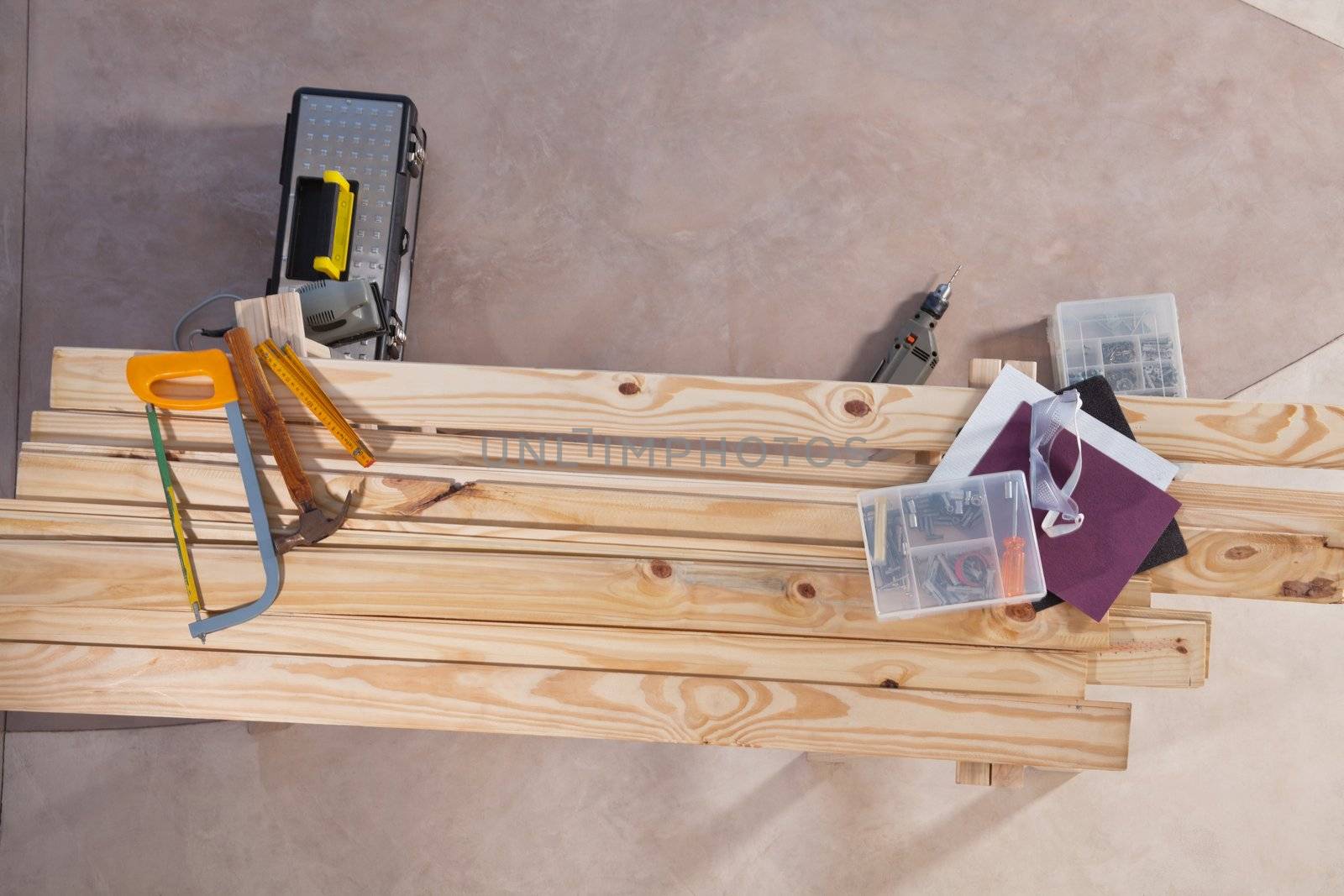 Set of construction tools lying on wooden plank