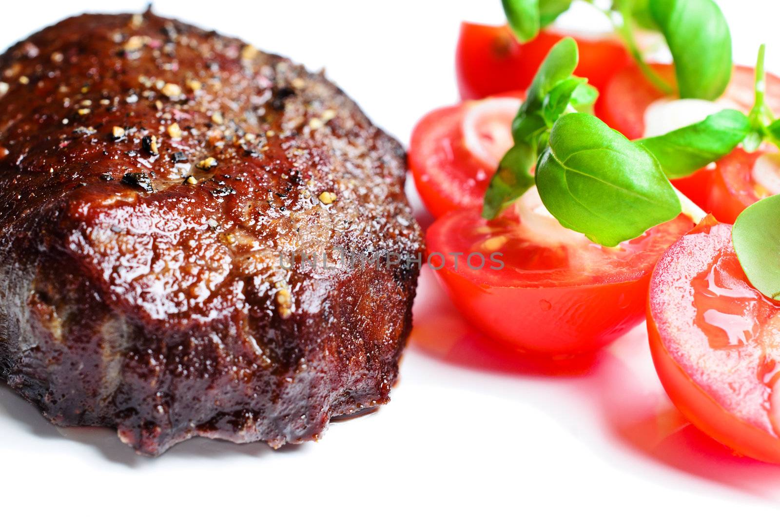 Steak with tomatoes close up by Nanisimova