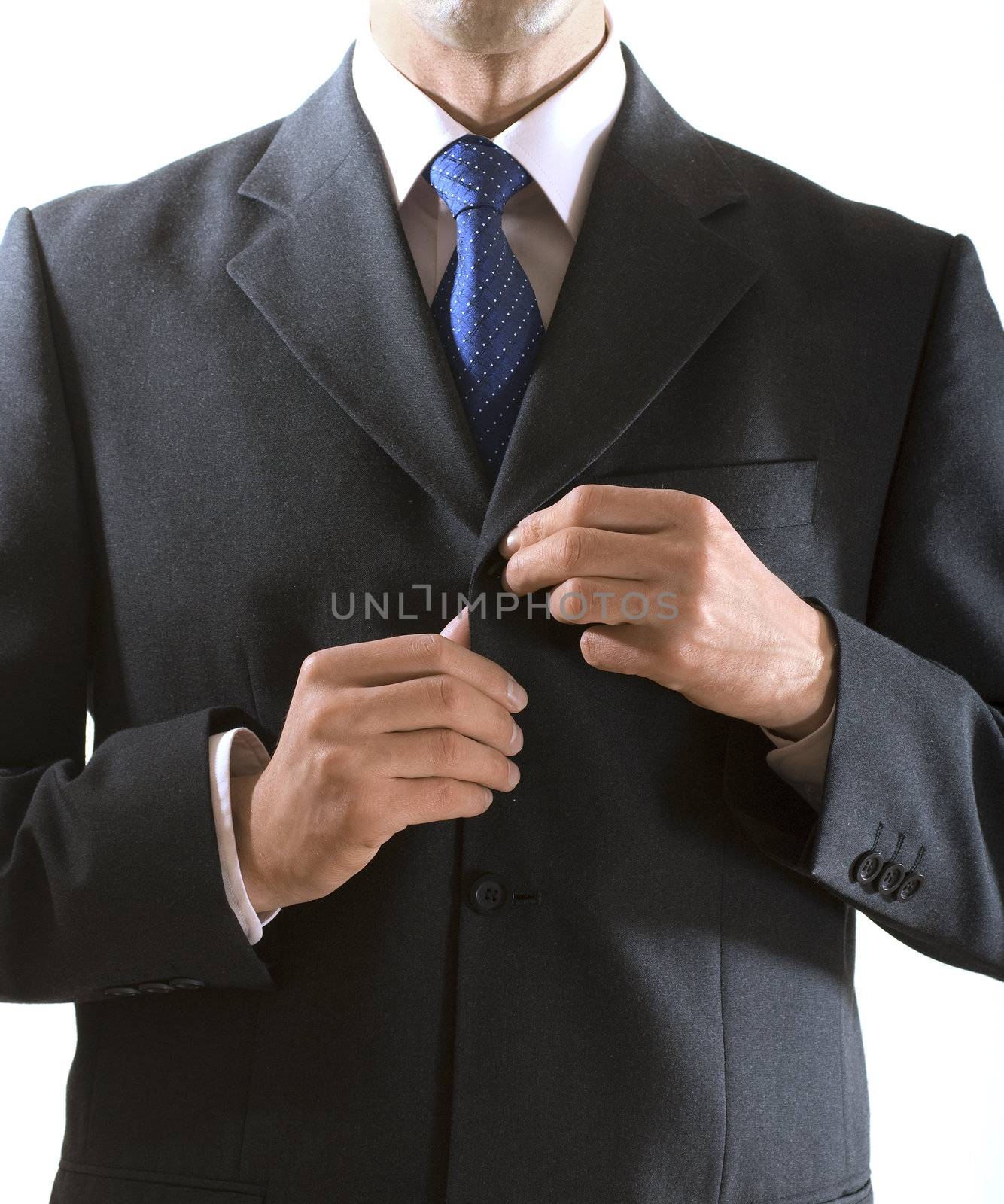 businessman buttons up the button on the suit