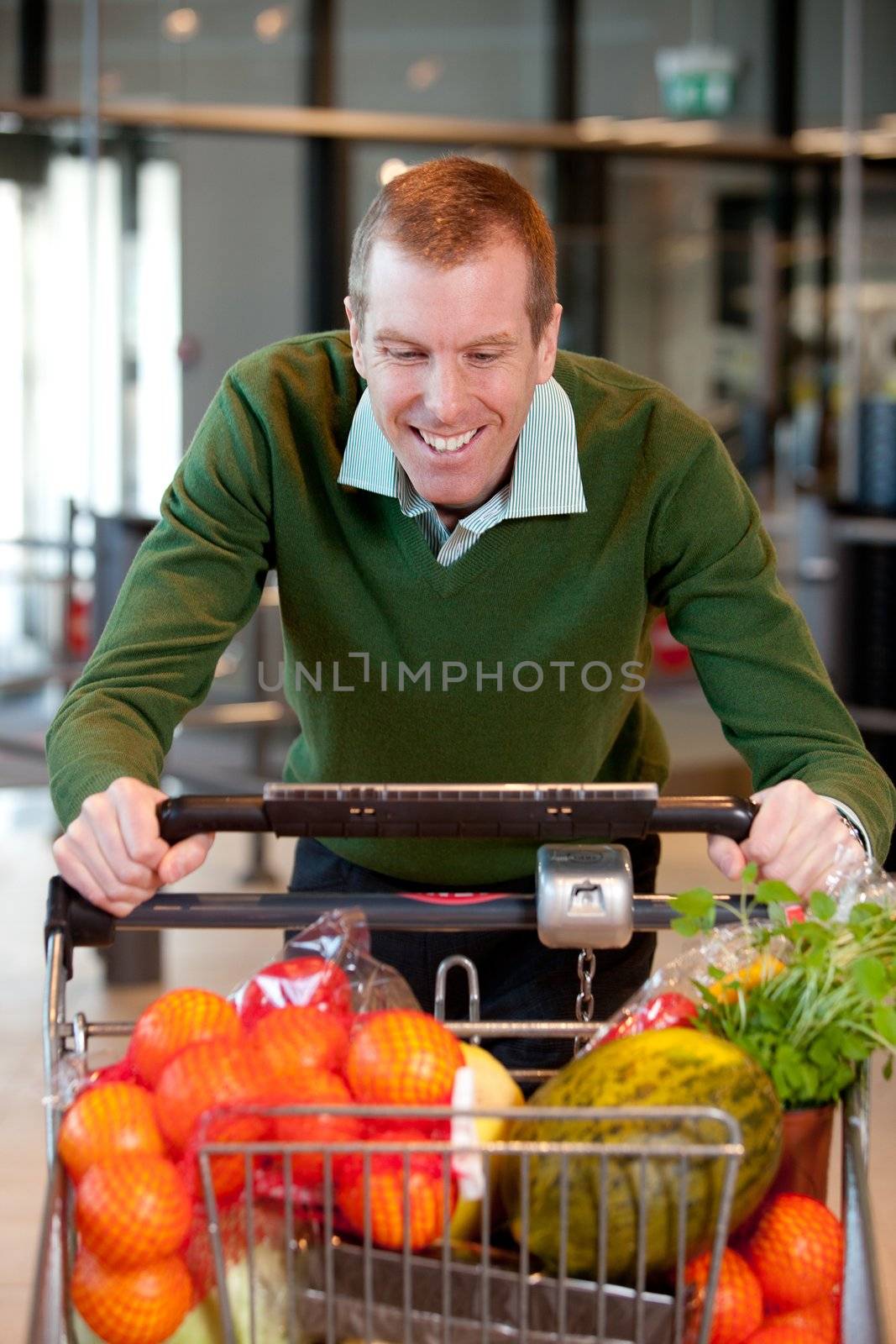 Portrait of a man pushing a grocery cart in a grocery store