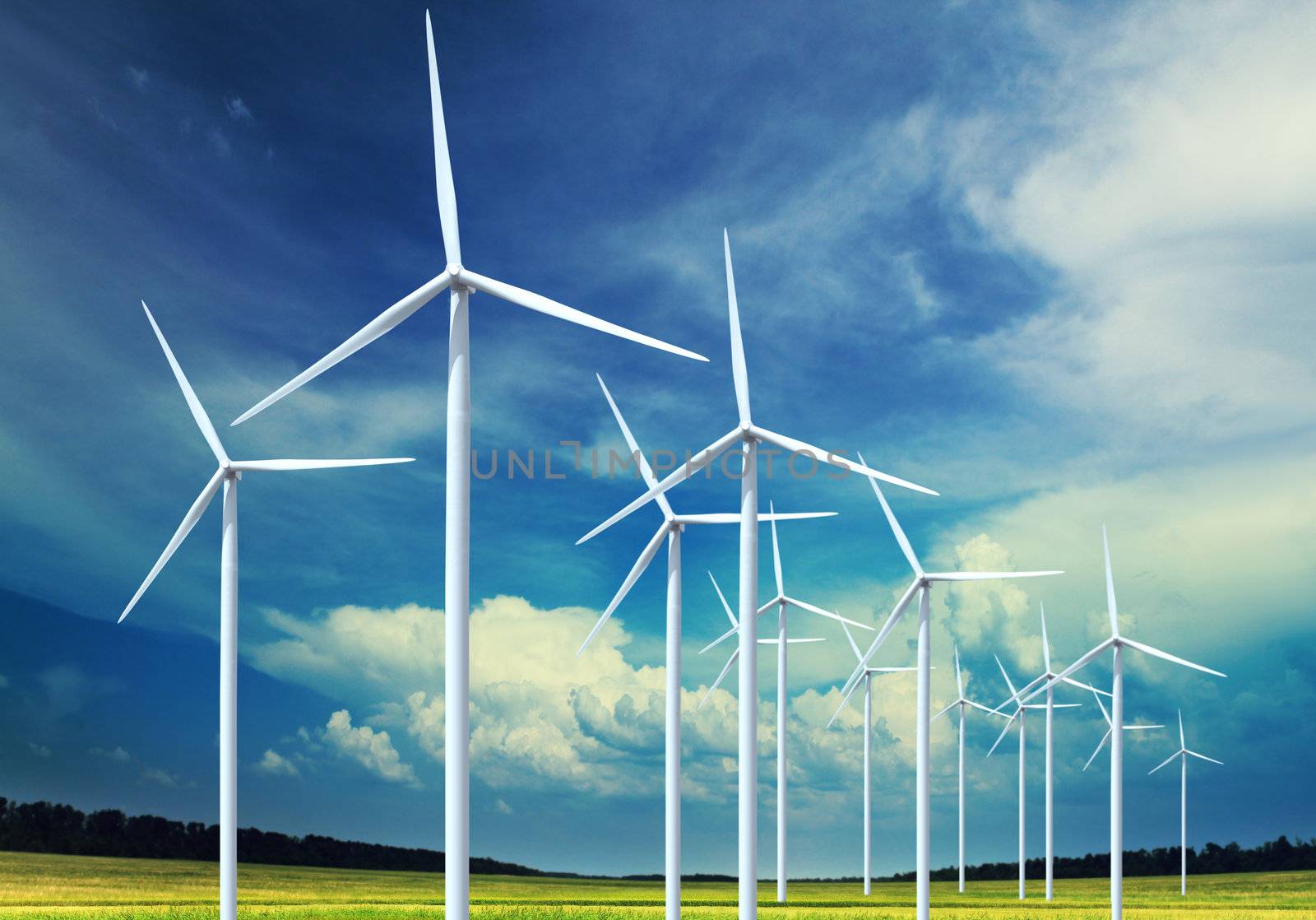 Beautiful green meadow with Wind turbines generating electricity