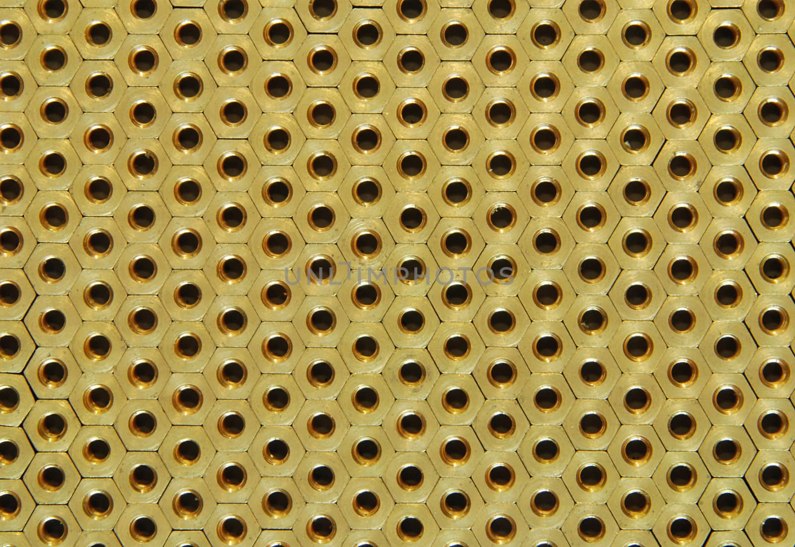 Background made of golden hexadonal screw-nuts