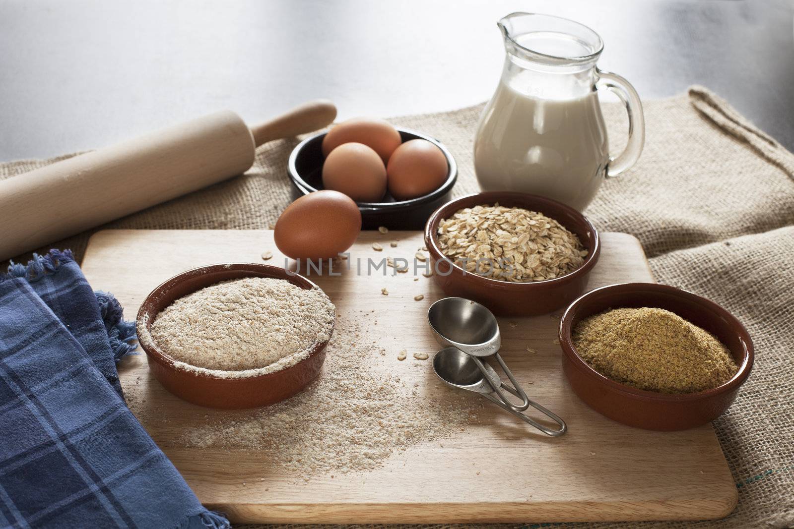 Ingredients for whole grain healthy bread, whole wheat flour, rolled oats and wheat germ with milk and eggs.