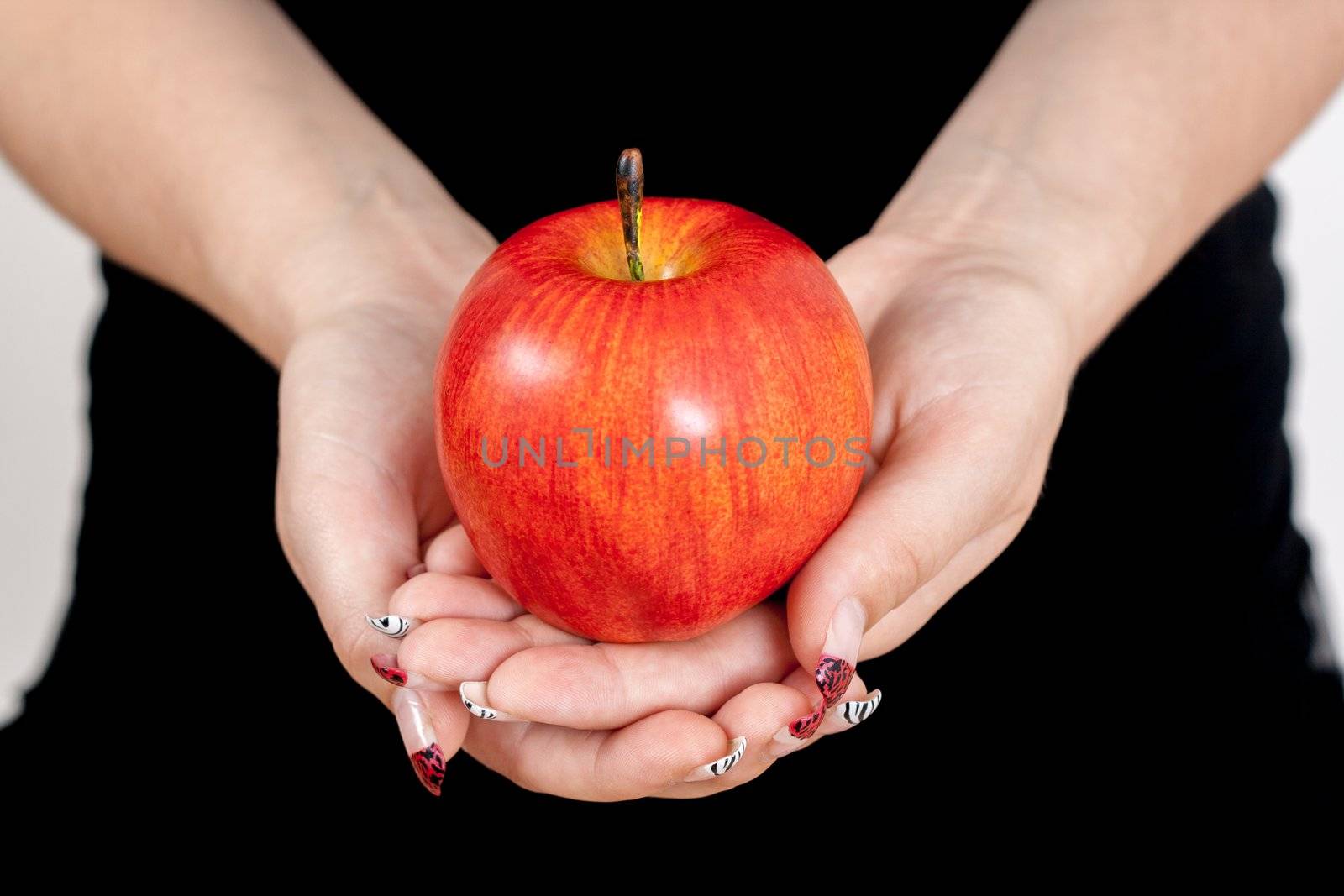 big red apple in woman hands 