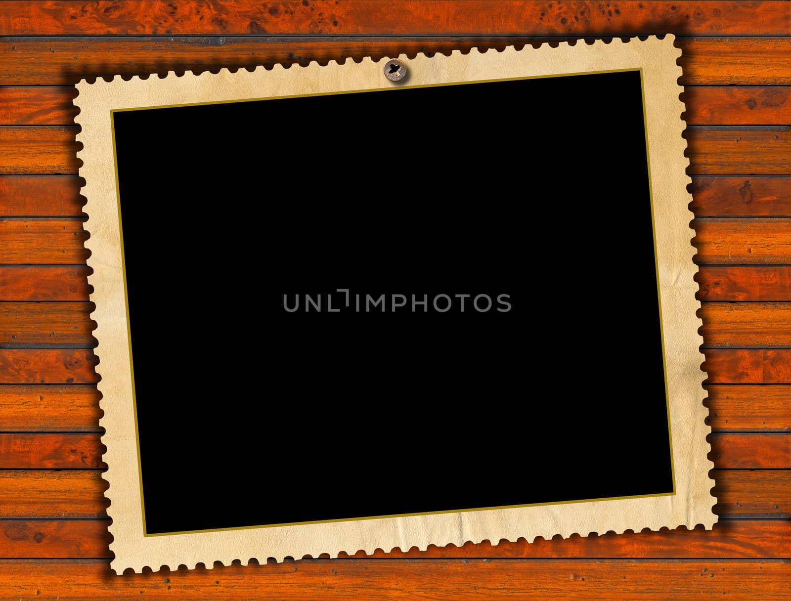 Aged photo frame on wood background with ragged edge
