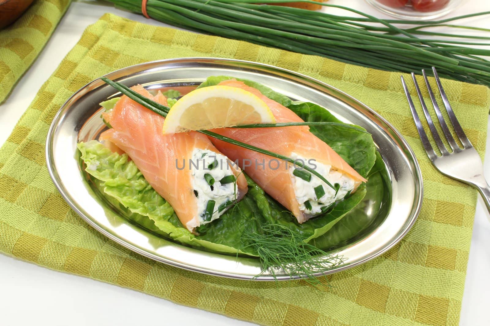 delicious Salmon rolls with cream cheese and chives on a light background