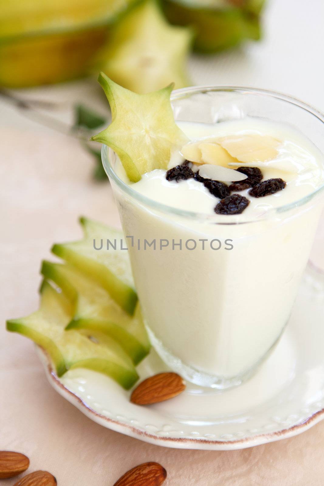 Yogurt with starfruit,almond and raisin in glass