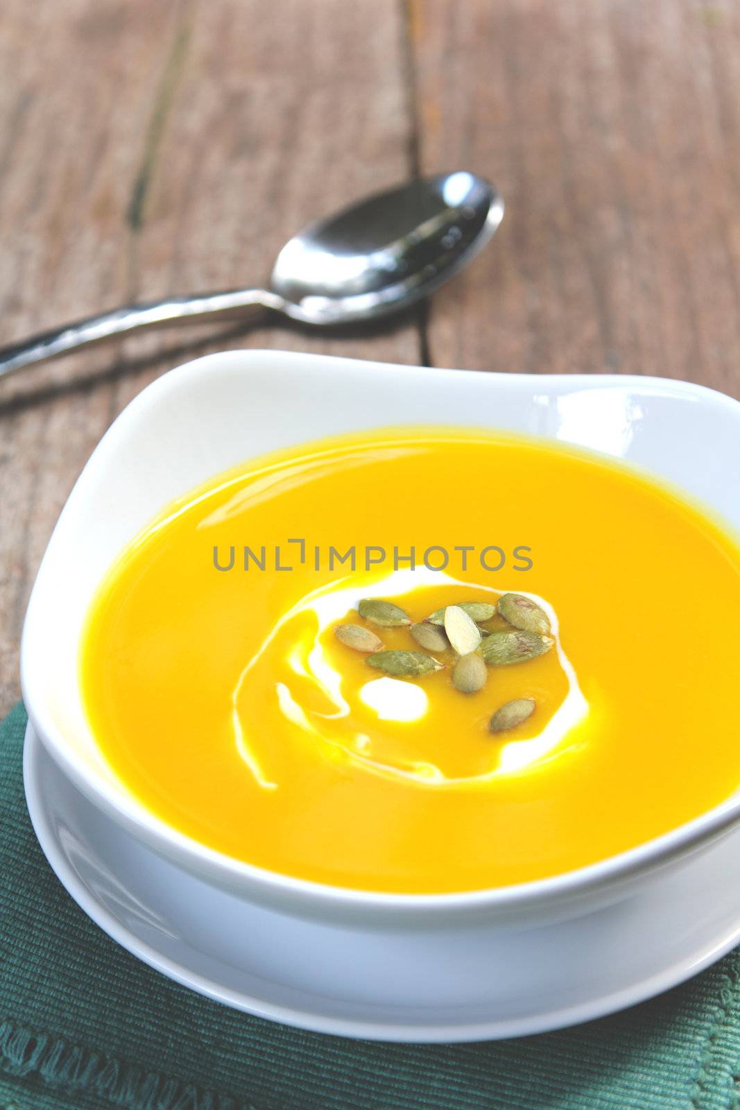 Pumpkin soup with cream and pumpkin seed on top