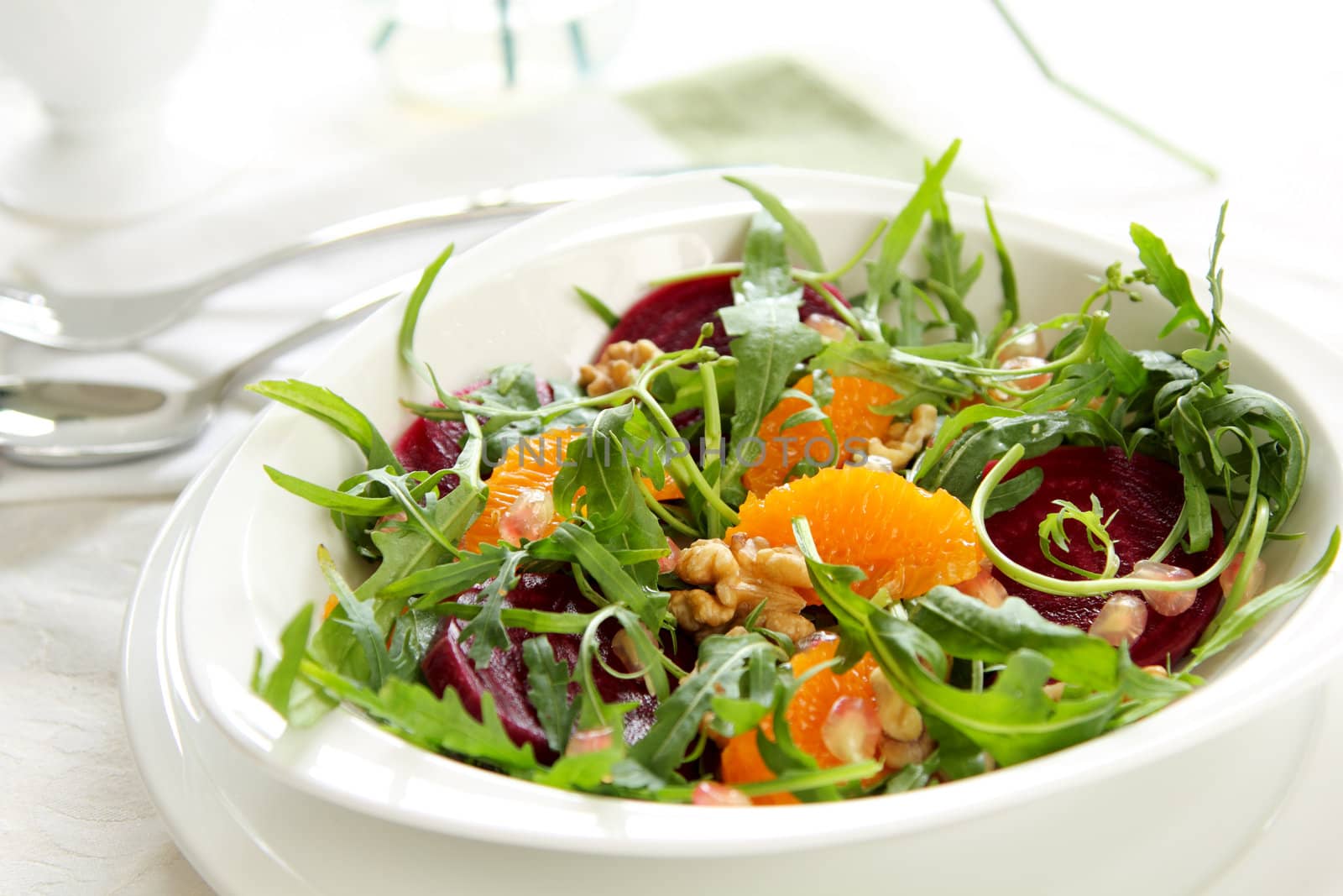 Orange,Beetroot, with walnut  rocket salad in white dish