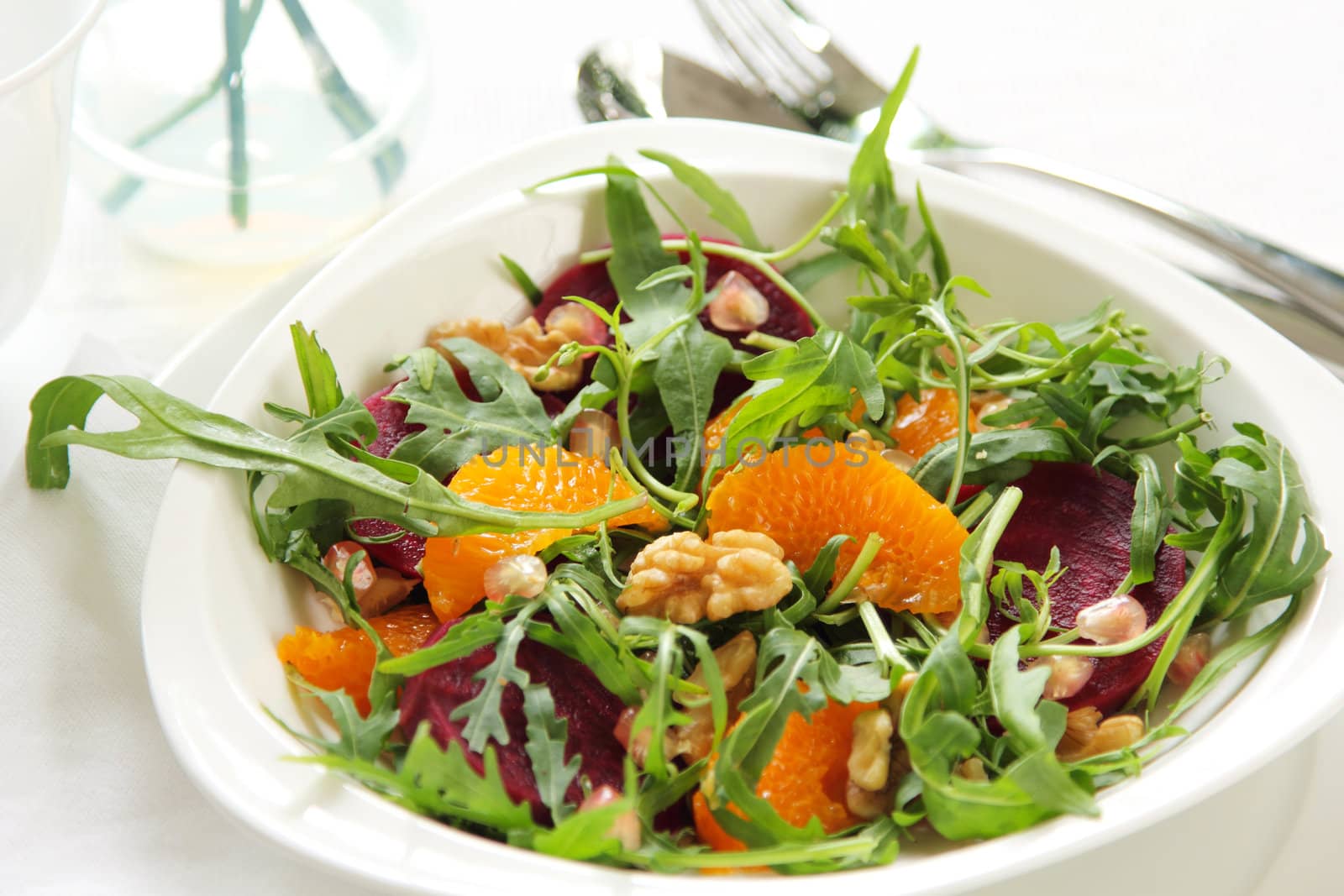 Orange,Beetroot, with walnut  rocket salad in white dish