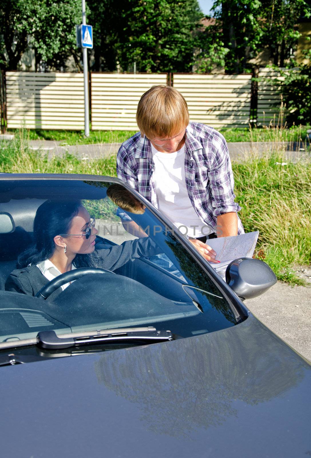 Male tourist asking female driver about direction