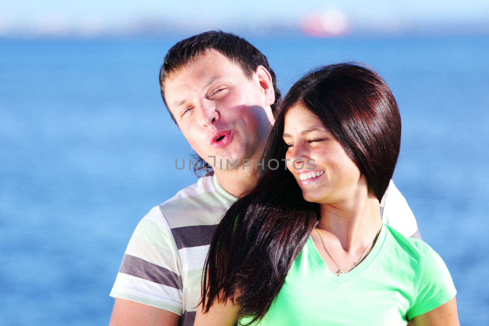 man and woman hug in the sky sea on background