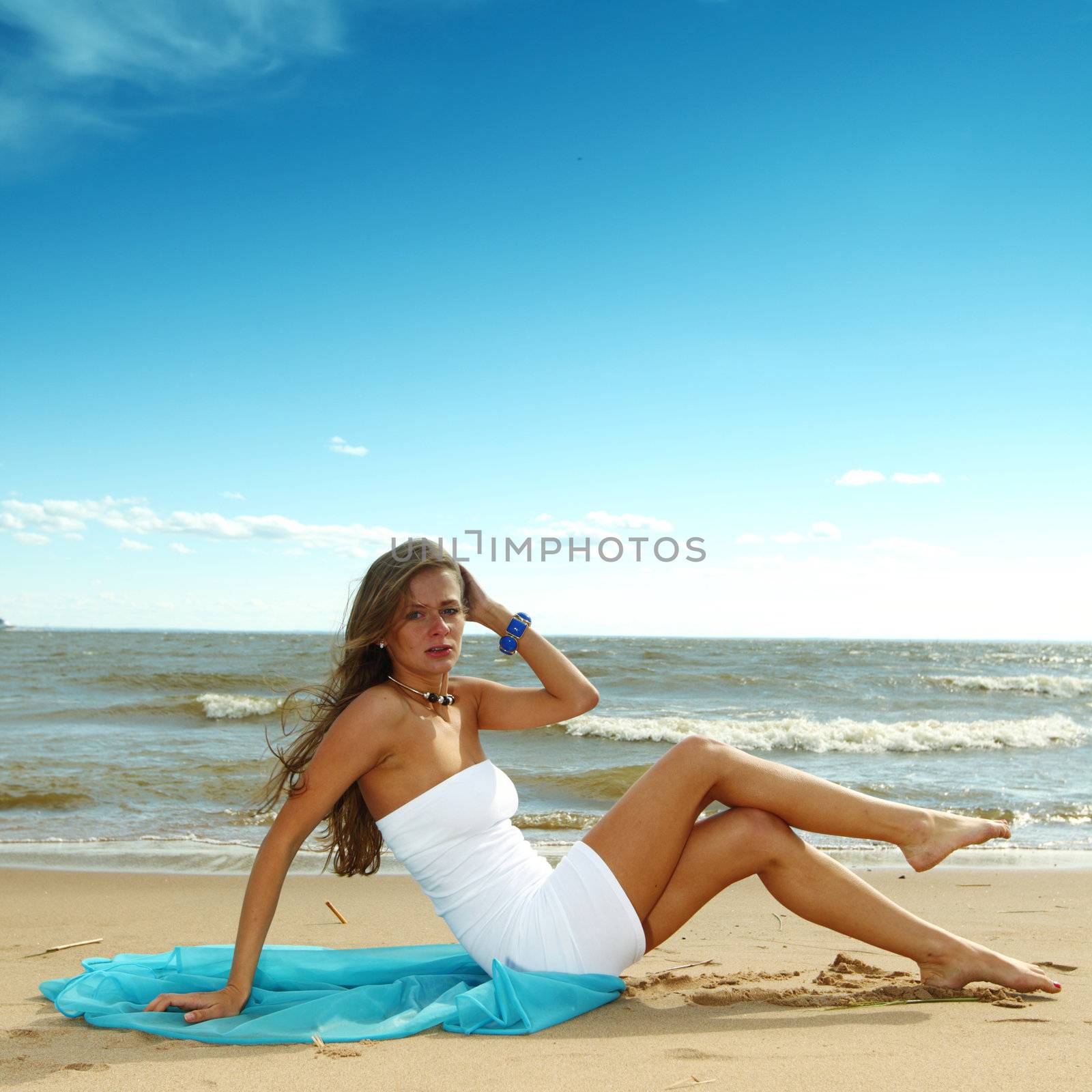 woman laying on sand sea on background