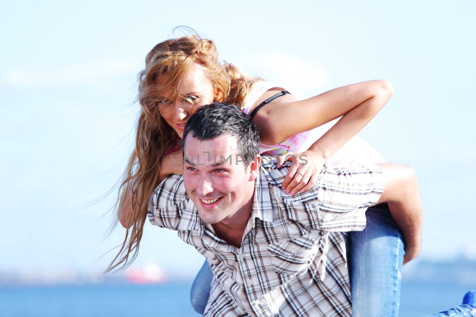 man and woman hug in the sky and sea on sea