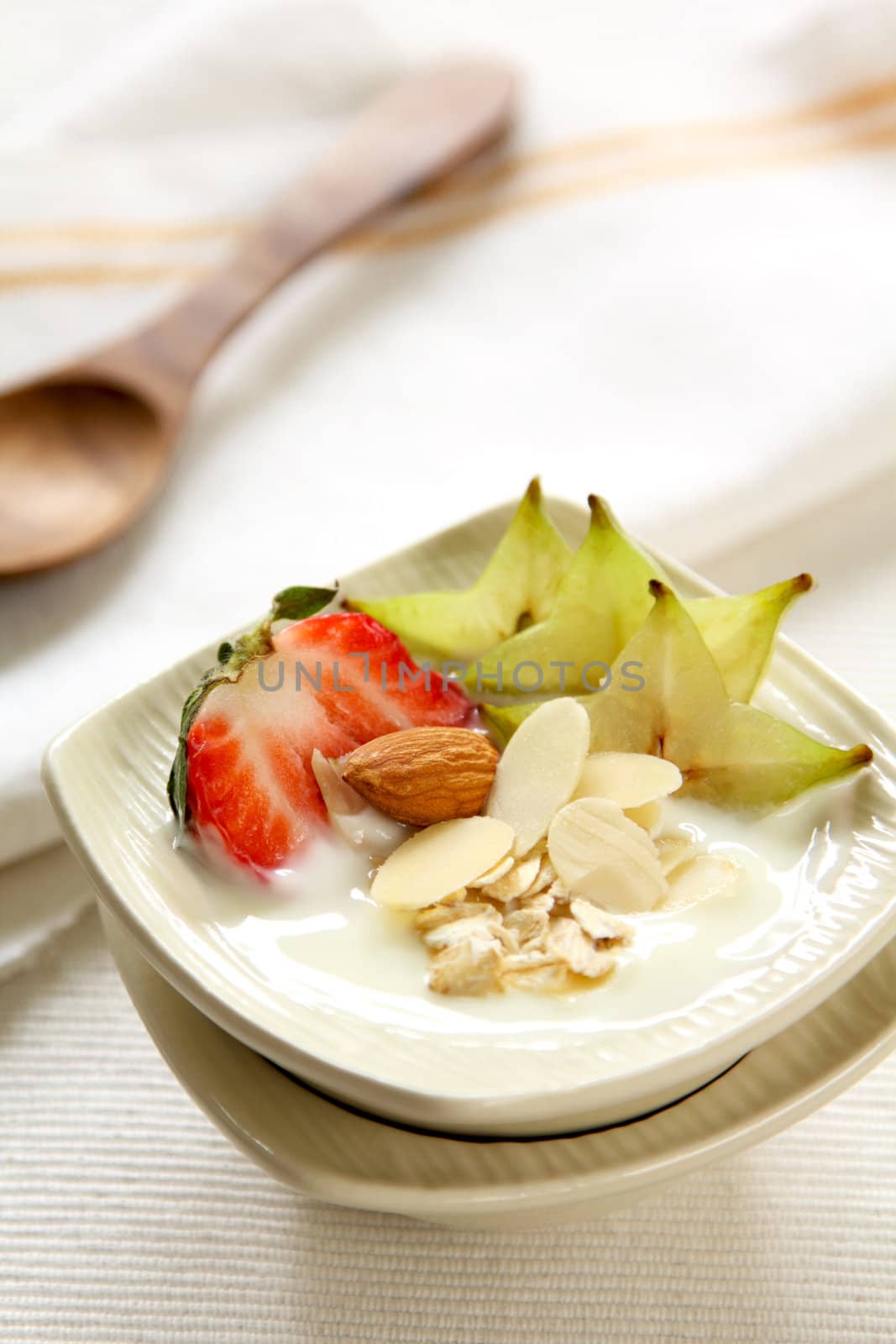 Yogurt with strawberry,starfruit and almond in small bowl