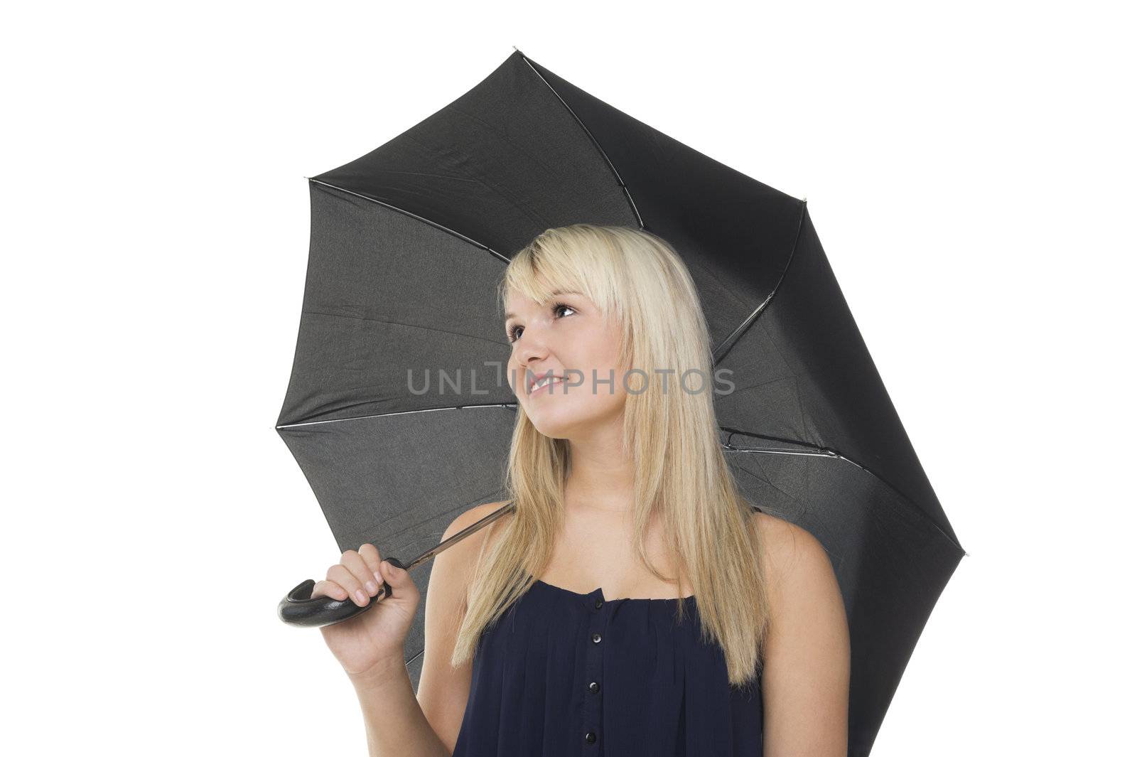 Beautiful blonde woman standing under an opened umbrella which is resting across her shoulder, isolated studio portrait