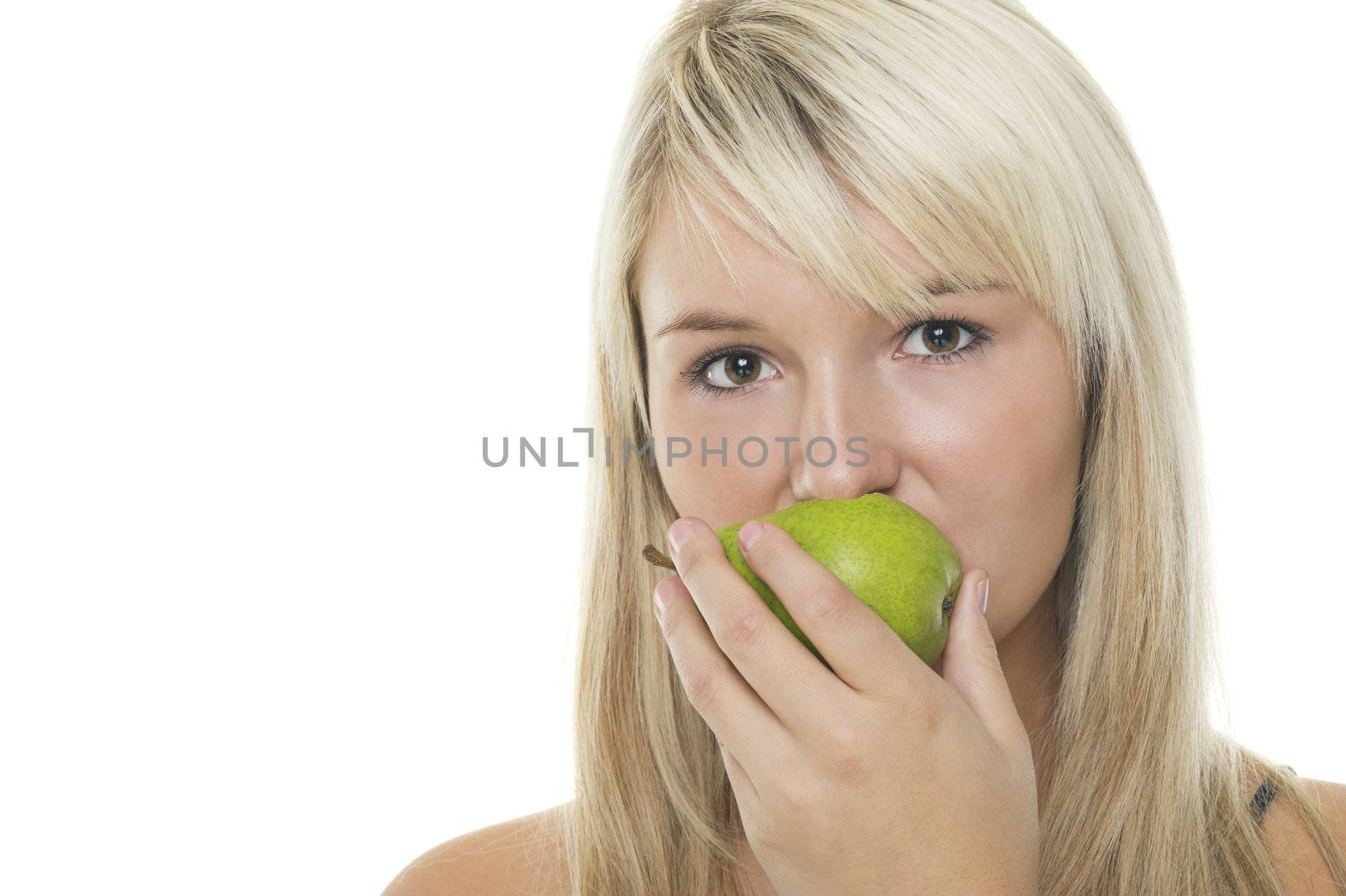 Woman eating a green pear by MOELLERTHOMSEN